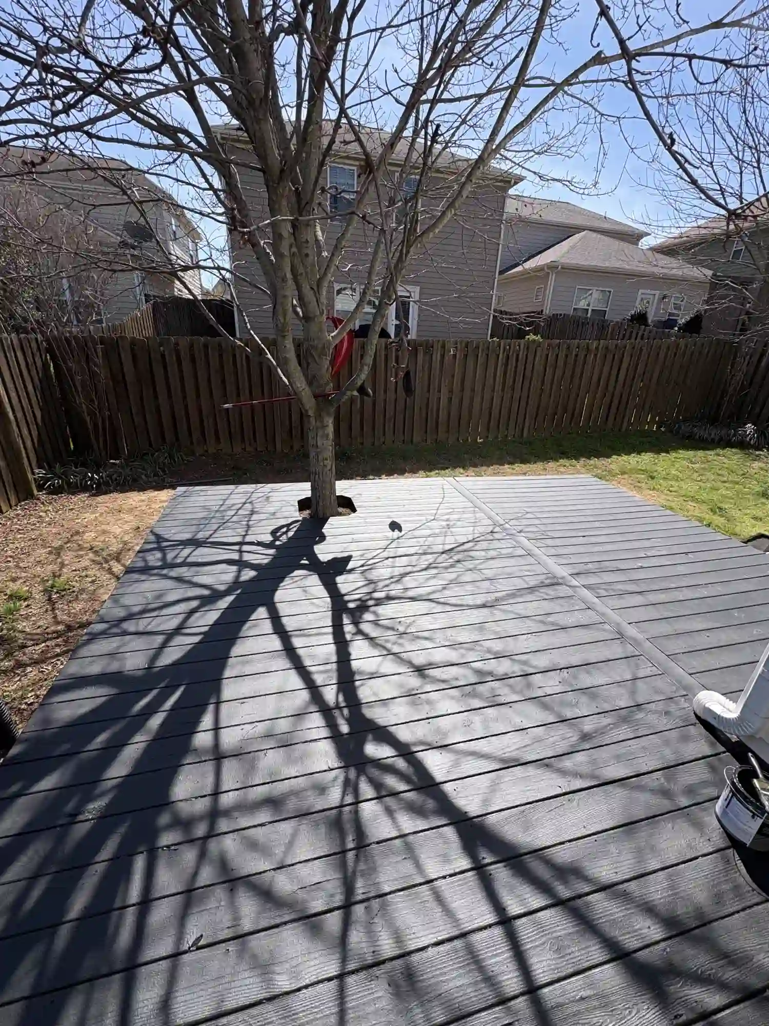 Refinished backyard deck in charcoal finish, fenced yard