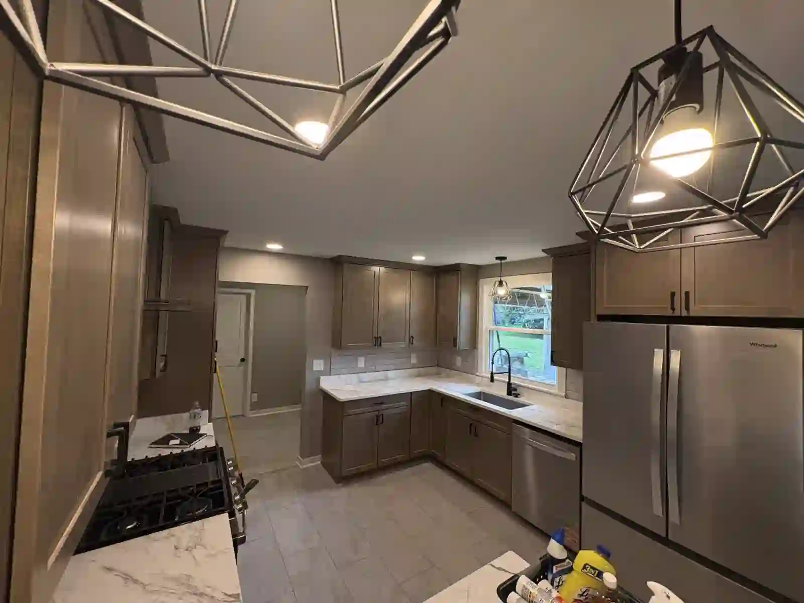 Kitchen at night with geometric pendant lighting