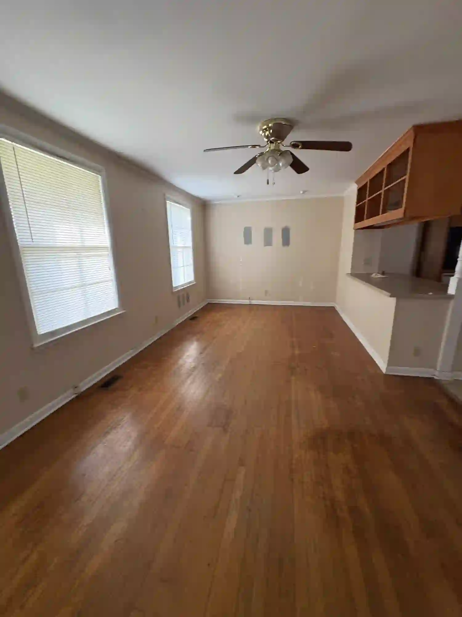 Living room before renovation with original hardwood floors