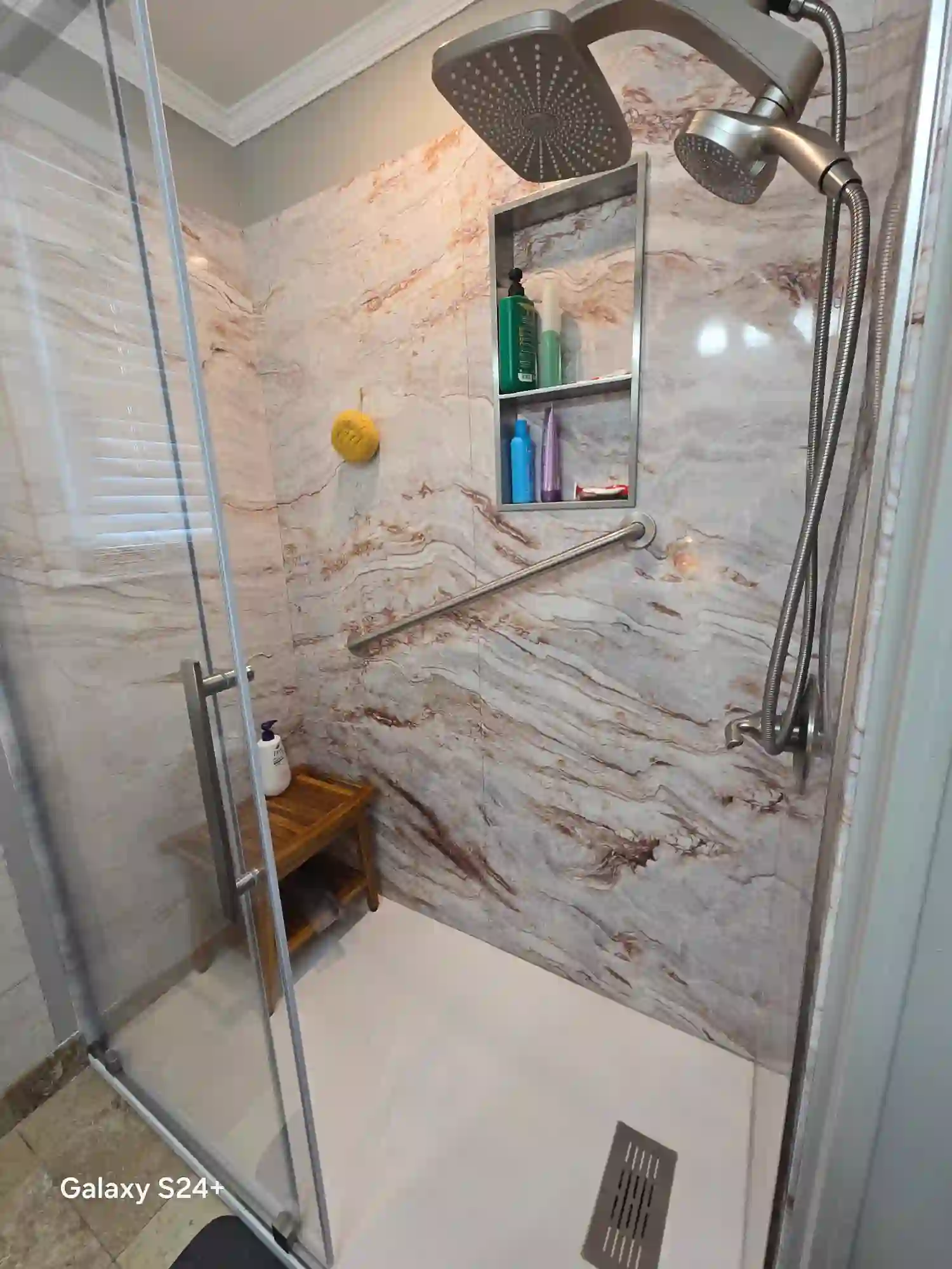 Marble-panel walk-in shower with rainhead, handheld, and teak bench